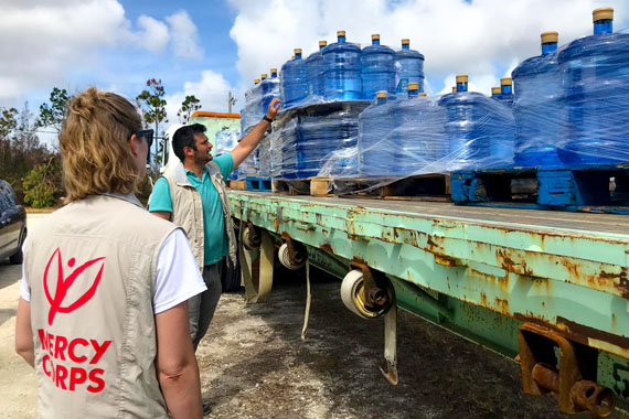 Mercy Corps team members distribute hundreds of bottles of water in Freeport in the Bahamas.