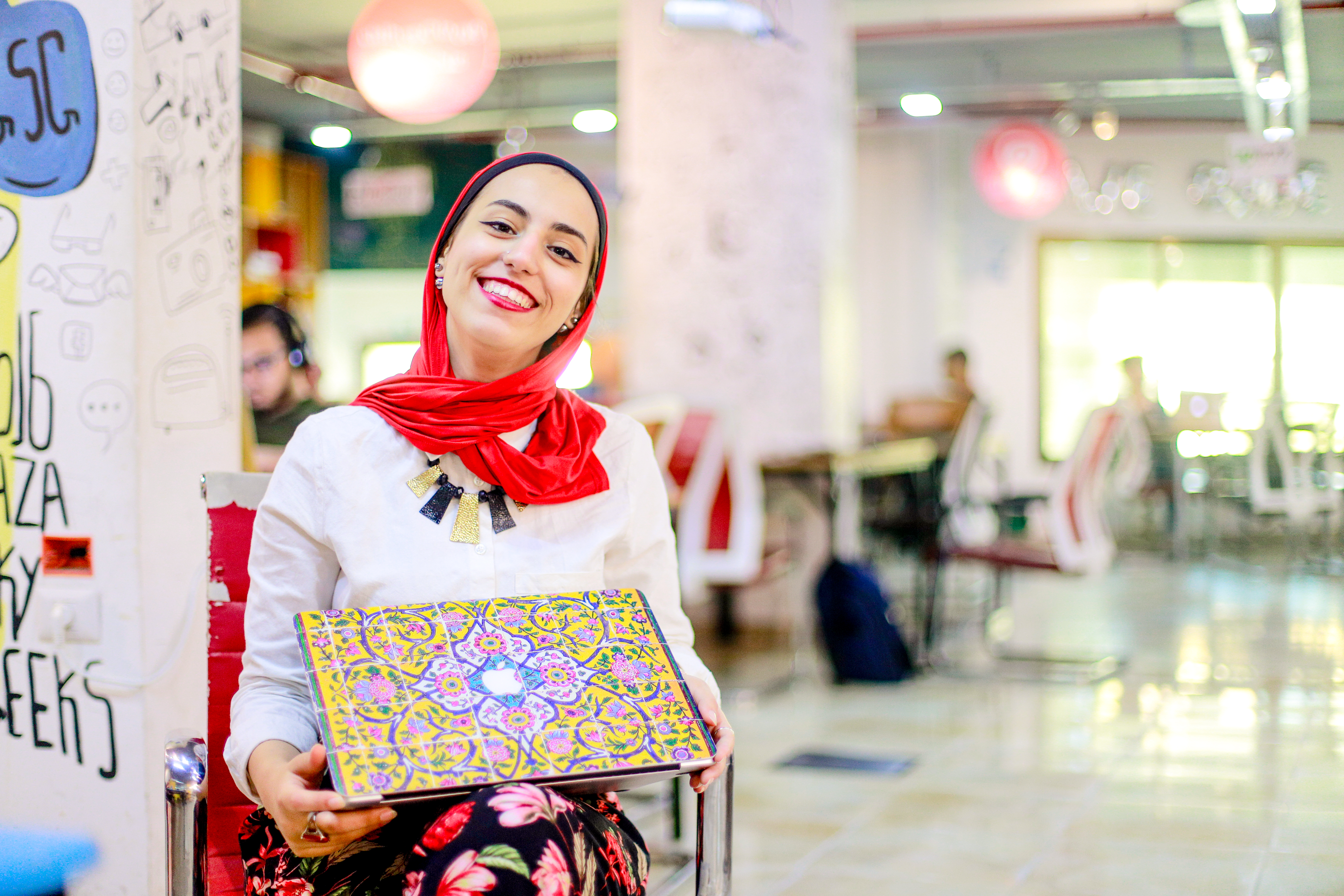 Eman, a freelance medical translator and graduate of Mercy Corps' Gaza Sky Geeks freelance training, with her laptop