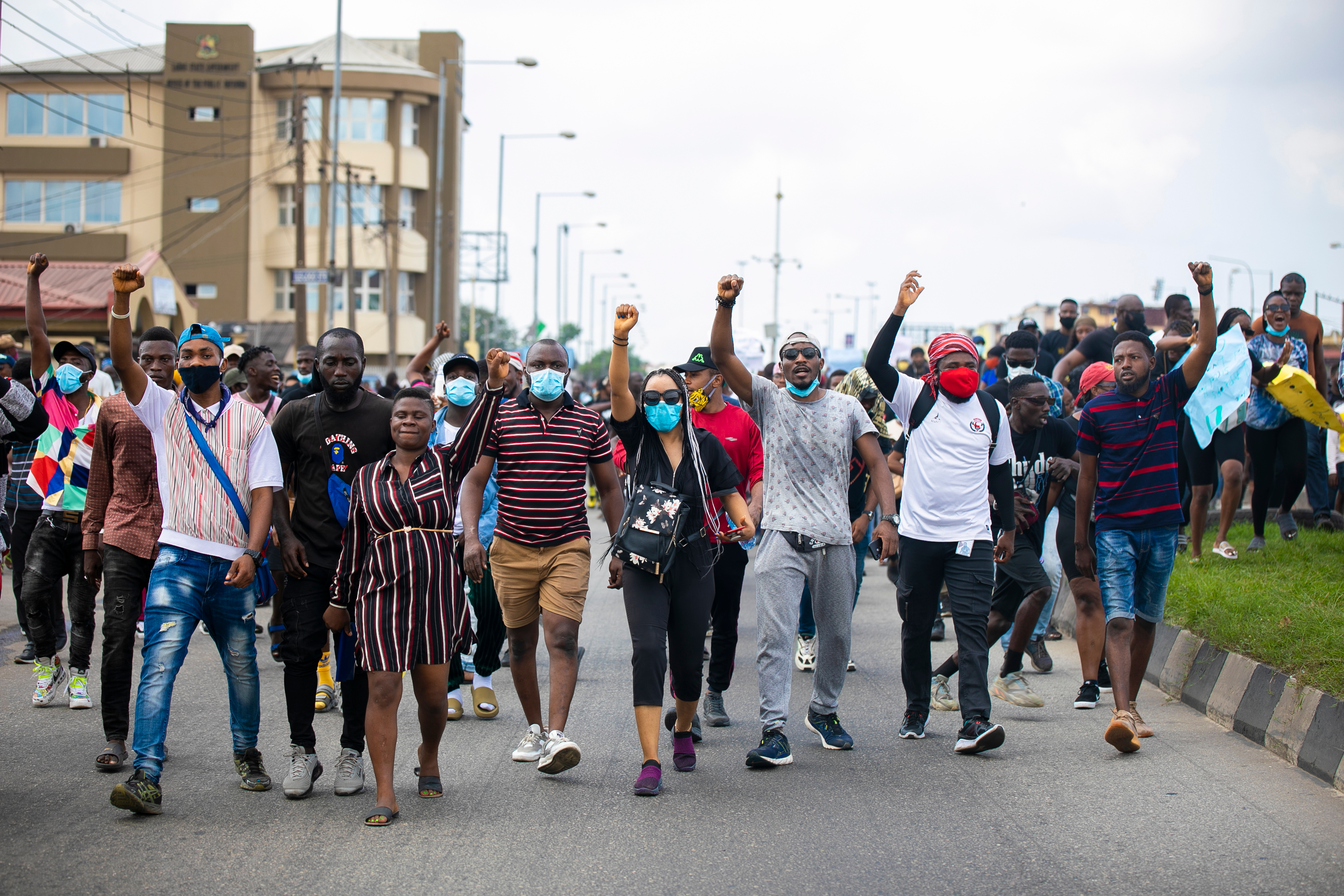 A group of protestors marching down a street.