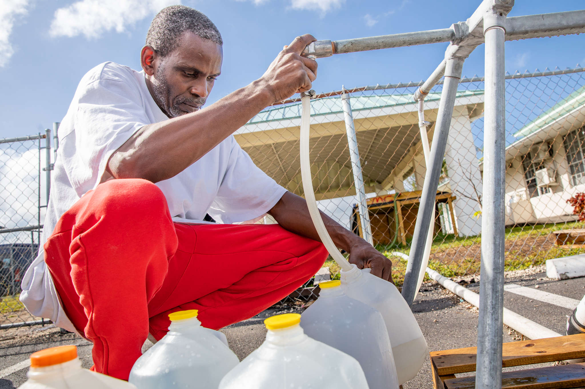 Bahamian filling water jugs.