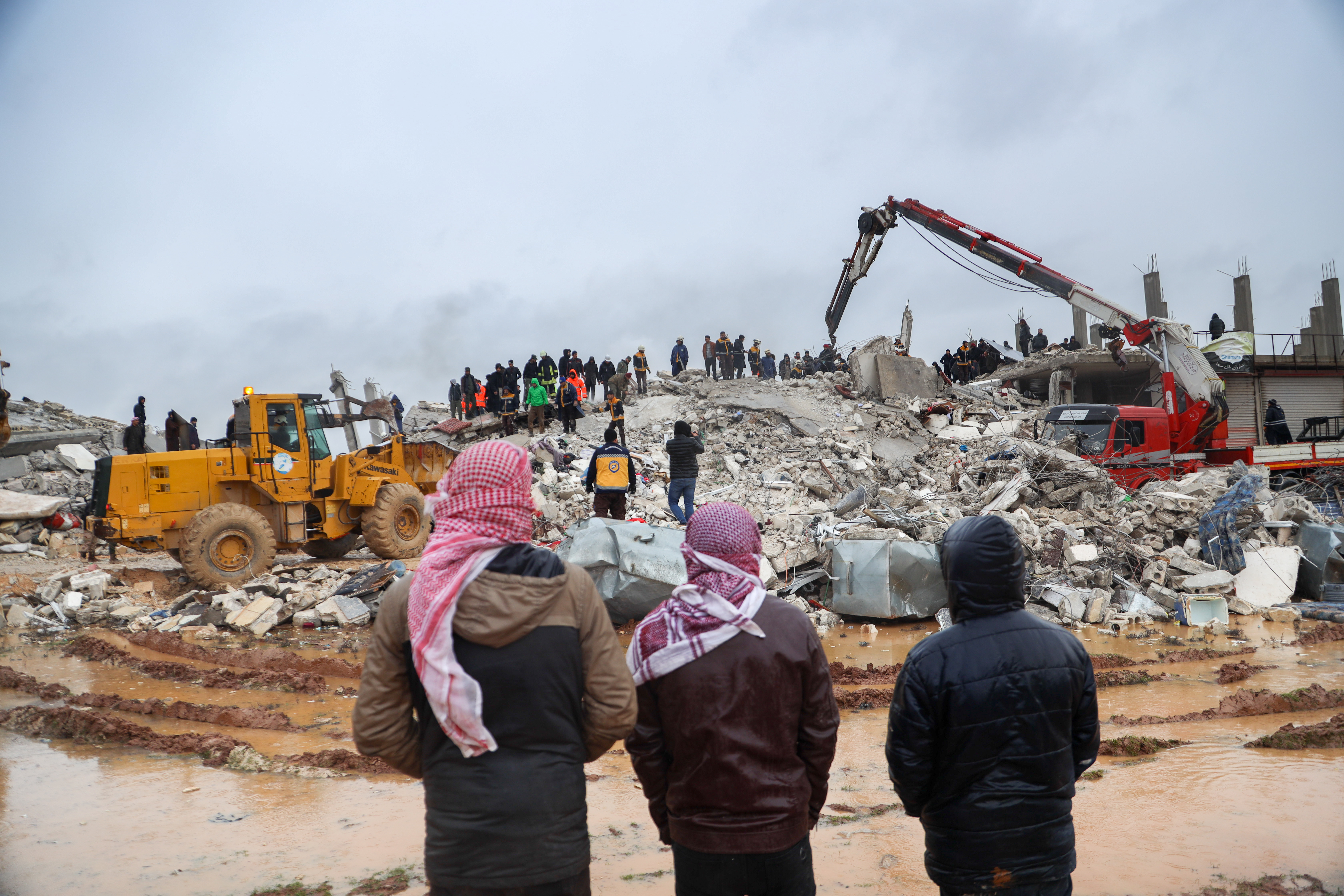 In Sarmada, Northwest Syria, rescue crews rush to a collapsed building in the wake of massive earthquakes that struck the region.