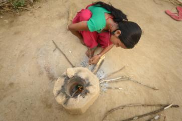 Sarmila lighting a fire