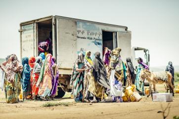 Women gathering around a truck