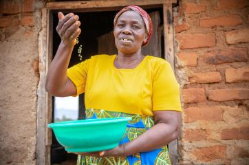 Kenyan farmer showing harvest.