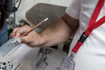 A person holds 3d-printed pencil grips designed and printed by trained field staff at zaatari refugee camp, jordan.