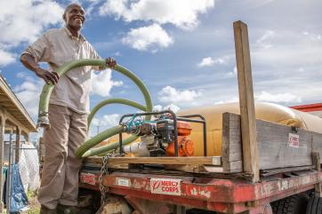 A person fills a 1,300 gallon bladder on the back of a truck with drinking water to be distributed to sites around freeport after hurricane dorian devastated the bahamas.