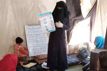 A person leads a presentation to to a family. 