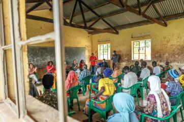 Chief executive officer of mercy corps, tjada d’oyen mckenna talks to colleagues during her visit to bidi bidi refugee settlement.