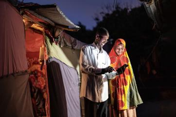 A father and daughter using a mobile device.