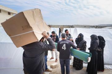 People carrying shipments of emergency supplies.