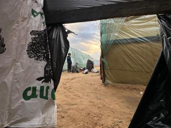 Makeshift tents and people in-between them