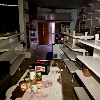 The shelves of a shop are completely empty of food and other supplies in the city of Rafah. Photo by ©Shadow Pro for Mercy Corps. 