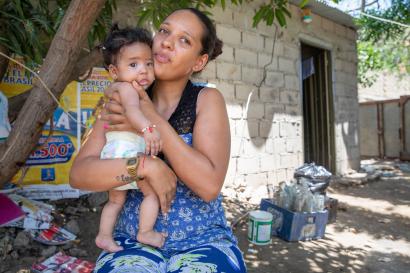 A person holds her three month-old daughter in colombia.