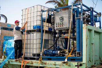 A person unloading a reverse osmosis plant.