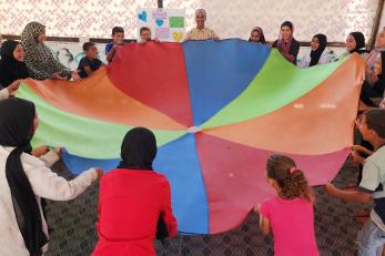 A group of young people engaging in a team building activity.