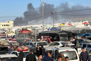 Explosions and smoke appear on the horizon as a result of israeli shelling. photo by ©shadow pro for mercy corps.