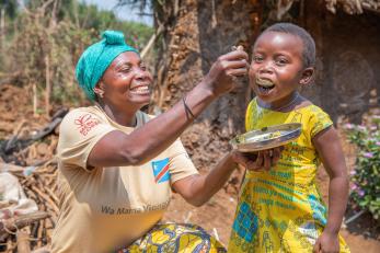 A woman feeds her child in the democratic republic of congo