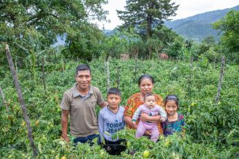 A family poses on a farm in guatemala.