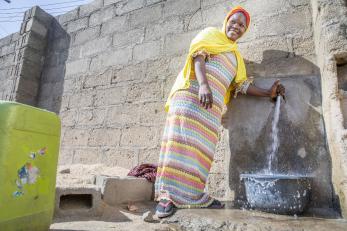 A woman in nigeria operates a water spout