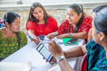 Farmers sitting at a table during a workshop.