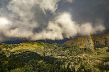 Rainbows forming over the rugged mountains of Timor-Leste.