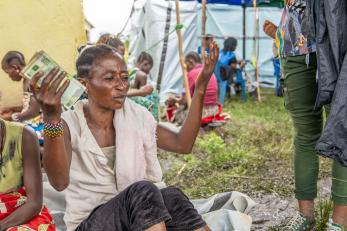 A person holding cash.