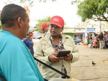 Mercy corps team member interviewing man on street