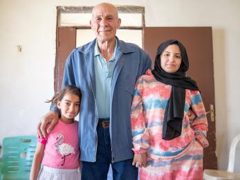 Three members of a family posing together.