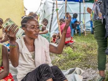 A person holding cash.