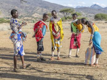 Kenyan women meeting in the outdoors.